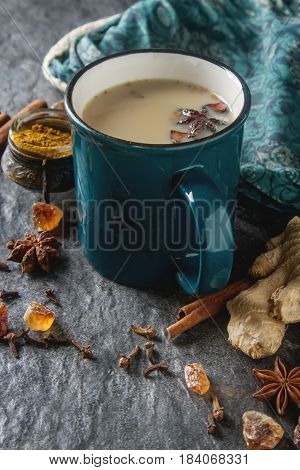 Traditional Indian Masala Tea In Ceramic Cup With Spices To Milk