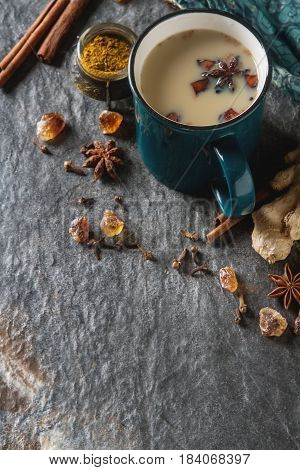 Traditional Indian Masala Tea In Ceramic Cup With Spices To Milk