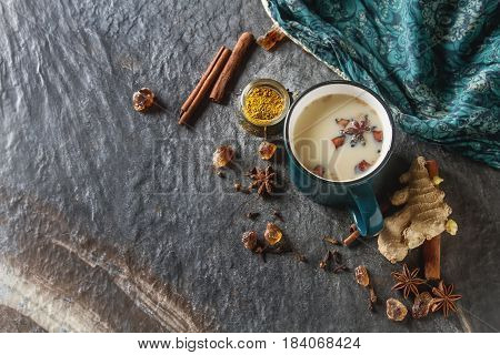 Traditional Indian Masala Tea In Ceramic Cup With Spices To Milk