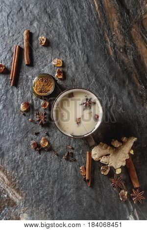 Traditional Indian Masala Tea In Ceramic Cup With Spices To Milk