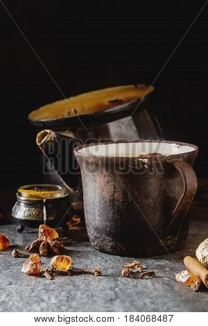 Traditional Indian Masala Tea In Ceramic Cup With Spices To Milk