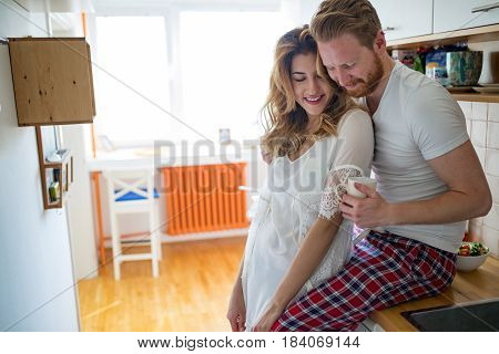 Romantic couple in love speding time together in kitchen