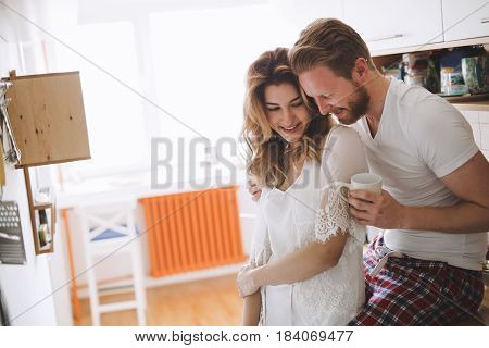 Romantic couple in love speding time together in kitchen