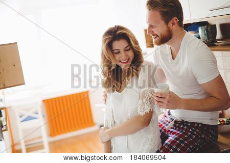 Romantic couple in love speding time together in kitchen