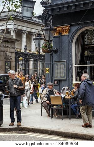 LONDON, GREAT BRITAIN - MAY 9, 2014: Here is the ebullient street life and unidentified people in the pub next to the British Museum.