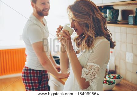 Romantic couple in love speding time together in kitchen