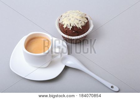 Classic espresso in white cup with homemade cake and chocolate on white background