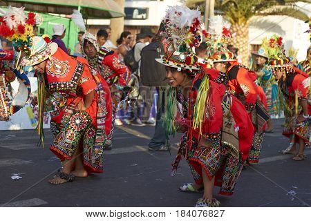 ARICA, CHILE - FEBRUARY 11, 2017: Tinkus Dance Group dressed in ornate costumes performing a traditional dance during a street parade at the annual Carnaval Andino con la Fuerza del Sol.