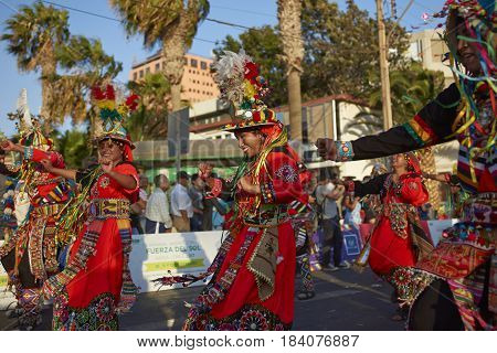 ARICA, CHILE - FEBRUARY 11, 2017: Tinkus Dance Group dressed in ornate costumes performing a traditional dance during a street parade at the annual Carnaval Andino con la Fuerza del Sol.