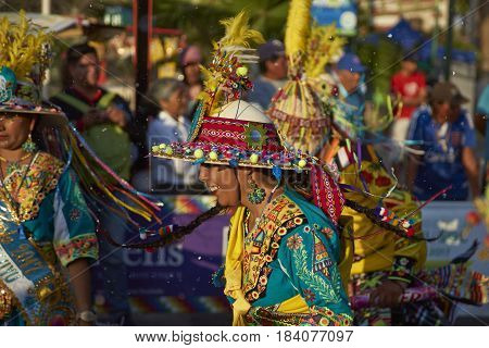 ARICA, CHILE - FEBRUARY 11, 2017: Tinkus Dance Group dressed in ornate costumes performing a traditional dance during a street parade at the annual Carnaval Andino con la Fuerza del Sol.