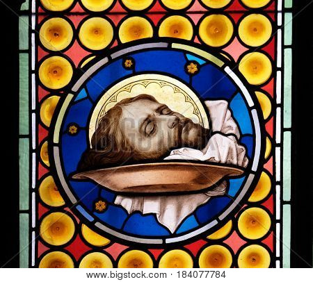 ROME, ITALY - SEPTEMBER 03: The head of Saint John the Baptist, stained glass window in Basilica of Saint Sylvester the First (San Silvestro in Capite) in Rome, Italy on September 03, 2016.