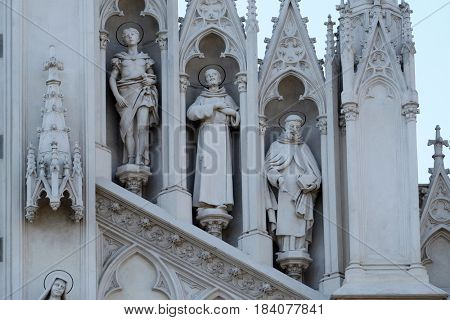 ROME, ITALY - SEPTEMBER 02: Statues of St. Victor, Francis of Assisi and Nicholas of Tolentino on the facade of Sacro Cuore del Suffragio church in Rome, Italy  on September 02, 2016.