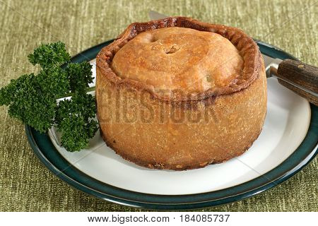 hand raised melton mowbray pork pie with parsley