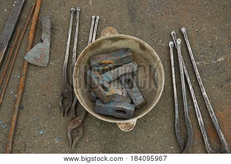 The blacksmith's tools are hammers and pincers