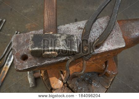 The blacksmith's tools are an anvil a hammer and pincers