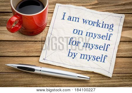 I am working on myself, for myself, by myself - handwriting on a napkin with a cup of coffee