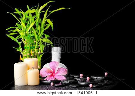 Spa Concept Of Hibiscus Flower, Bamboo, Thai Herbal Compress Ball, Beads And Candles On Zen Basalt S