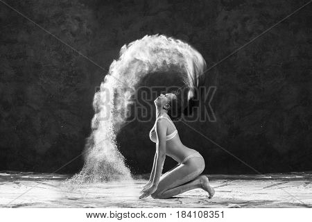 Black and white portrait of young dancer with white flour