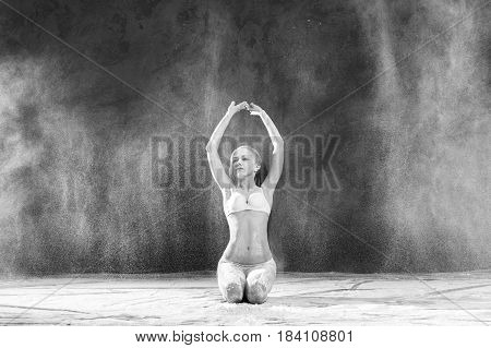 Black and white portrait of young dancer with white flour