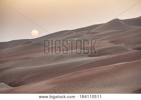 sunrise over a desert dunes in ruba Al kahli desert