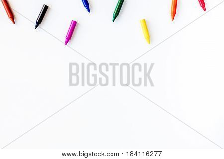 kids desk design with colorful crayons on white background top view space for text
