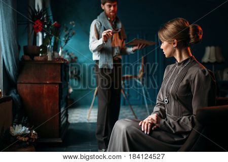 Painter work with female poseur in art studio