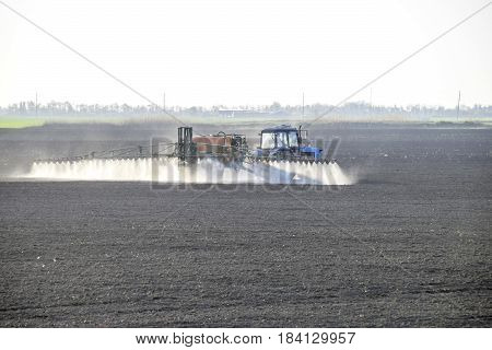 The Tractor Sprayed Herbicides On The Field. Chemistry In Agricu