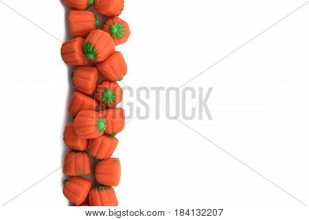Candy Pumpkins In Vertical Row On Isolated White