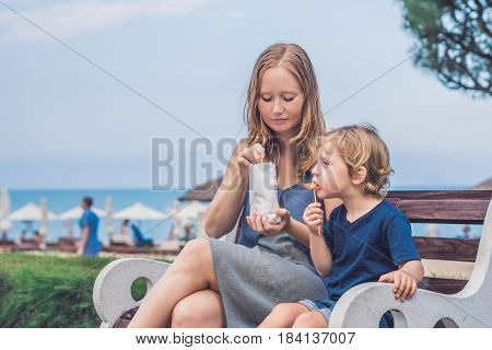 Mom And Son Eat Fried Sweet Potatoes In The Park. Junk Food Concept