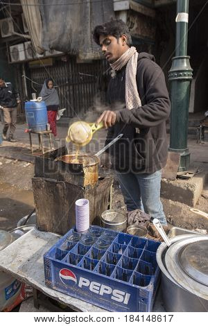 DELHI INDIA - DEC 20 : making of tradition india tea in street stall at chandni chowk in delhi on december 20 2014 india. india tea or chai is popular drink in india