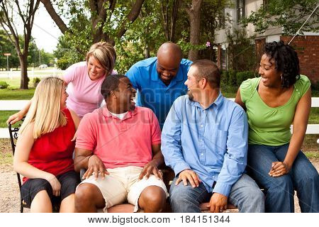 Happy commuinity group of people talking and laughing.