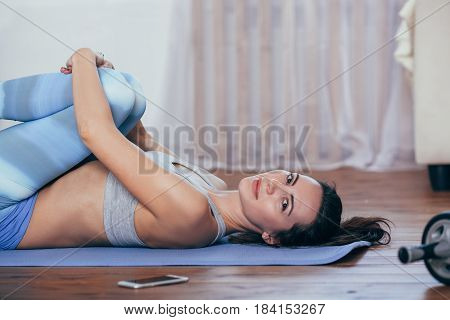 Young cheerful attractive woman practicing yoga, working out wearing sportswear