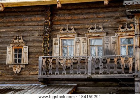 Windows with carved platbands in a wooden structure