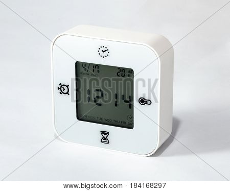 White universal desk clock alarm clock also showing days of the week date stopper and temperature on a white background
