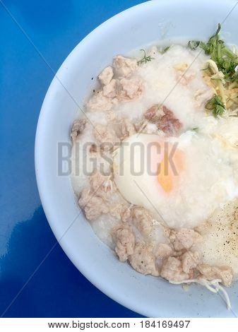 Traditional Thai Porridge Rice Gruel In White Bowl, Congee. In The Street Night Market.