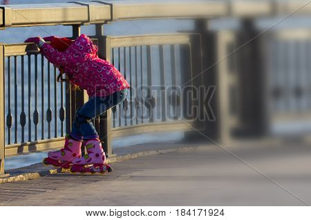 littel girl roller. pink dress. copy space