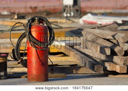 red fire extinguisher in a constraction background