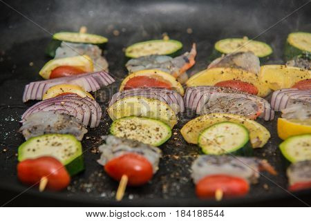 Barbeque sticks with meat and fresh vegetables