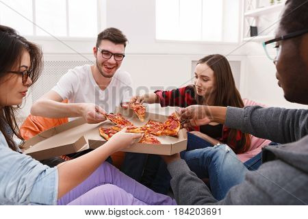 Lunch delivery. Happy people eating pizza at coworking office during break