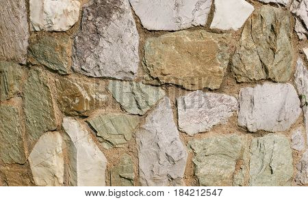 The wall of natural stone. Rocks stone wall texture background.