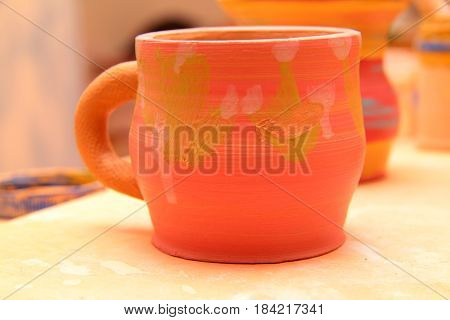 earthenware mug with handle colorized, pottery craft, moulding the pot with your hands, sculpting hands