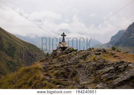 GEORGIA KAZBEGI Orthodox cross near Caucasus mountains.