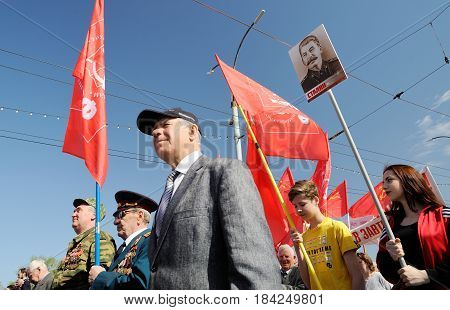 Orel Russia - May 1 2017: May demonstration. People marching with Stalin portrait and red Communist flags around