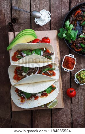 Above view of wheat wraps with mexican pork fajitas, selective focus, close view