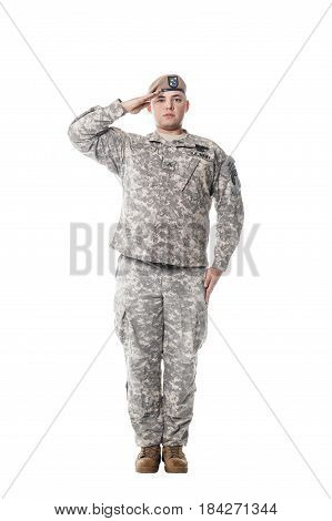 National Anthem is played. Army Ranger from Special Troops Battalion in universal Camouflage pattern Uniforms and Tan beret with Ranger Regiment crest is standing to attention and saluting proudly with honor and respect. Service to his country concept. Na