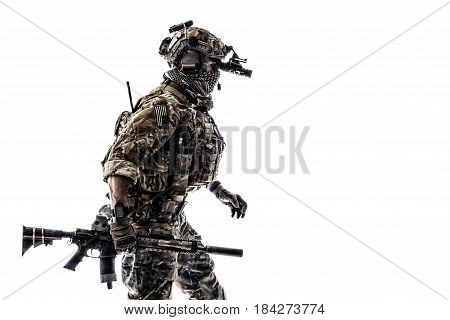 Army Ranger in field Uniforms with weapon, plate carrier and combat helmet are on, his face closed by Shemagh Kufiya scarf. Studio shot