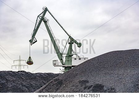 bagger at a huge black charcoal hill