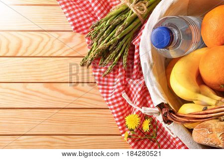 Picnic Wicker Basket With Food On Wood Table Top