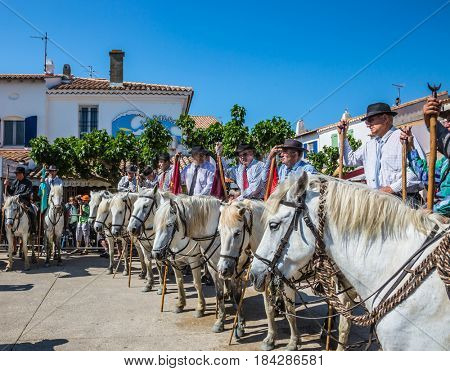 Sent-Mari-de-la-Mer, Provence, France - May 25, 2015. The concept of ethnographic and active tourism. Security guards on  white horses expect the beginning of a parade of the World festival of Gypsies