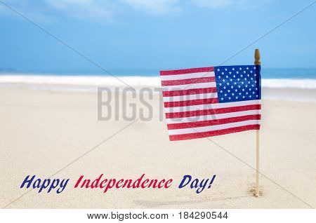 Independence Day USA background with american flag on the sandy beach near the ocean Patriotic USA concept